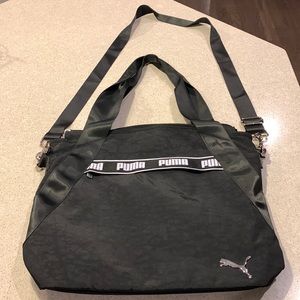 Puma black messenger bag with silver details/zipper and black on black design.